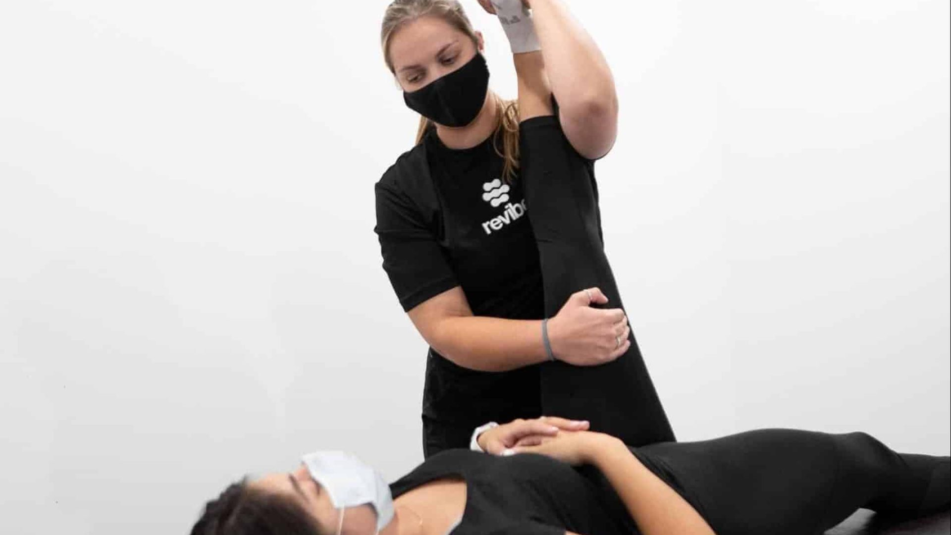 Kayla A-FRAME Registered physiotherapist performing stretches on customer.